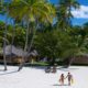 BORA BORA PEARL BEACH RESORT SPA couple walking on sand back to villa